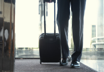 Cropped shot of a businessman entering hotel with luggage