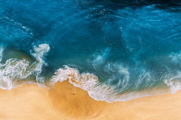 Aerial view of blue ocean waves in Kelingking beach, Nusa Penida island in Indonesia. Beautiful...