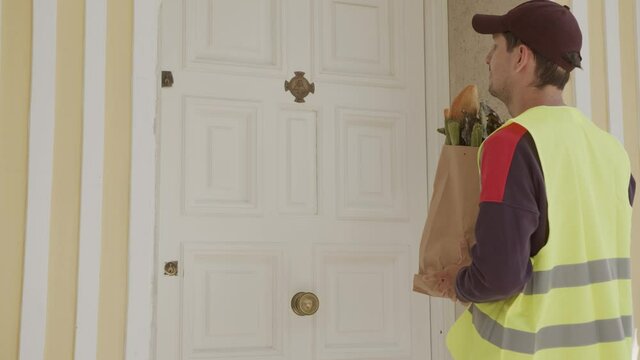 delivery man delivers the food at home