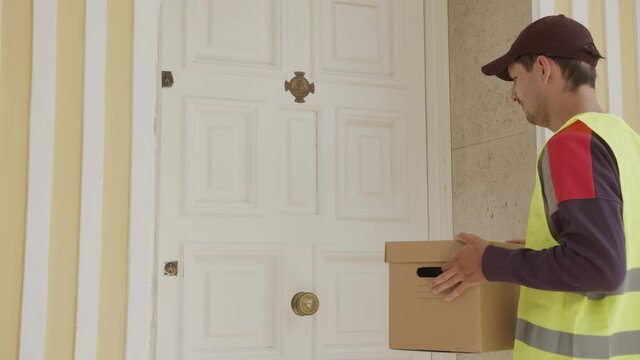 delivery man delivers the parcel at home