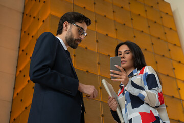 Male and female businesspeople studying some information online together