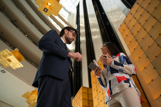 Executives Having Conversation In A Modern Corporate Office Hallway