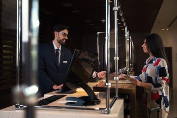 Elegant business lady receiving the keycard at an inn