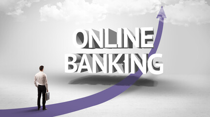 Rear view of a businessman standing in front of ONLINE BANKING inscription, successful business concept