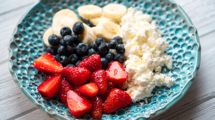 Morning pleasure. Healthy summer breakfast. Cottage cheese with berries fruits and honey. Cozy easy breakfast