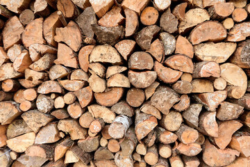 Large rural stack of firewood. Old firewood. Background.