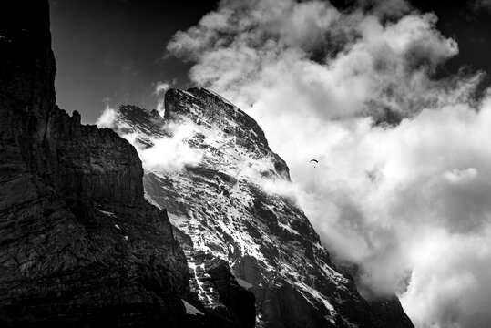 Paraglider in front of Eiger north face in black and white