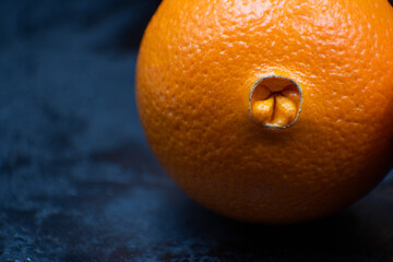 Navel oranges against a dark background