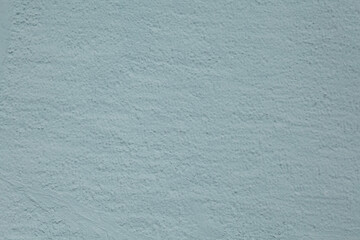 Texture of rough painted bluish tinted stucco.