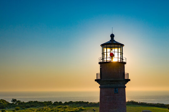 Gay Head Lighthouse silhouetted against a golden sunset sky, Aquinnah, Martha's Vineyard, Massachusetts