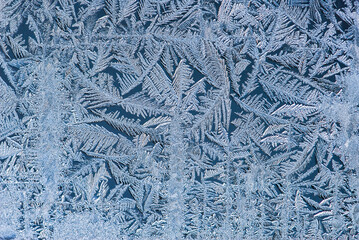 Nice frost pattern on glass in cold temperature colors for summer heat, abstract background