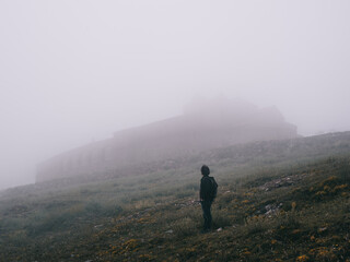 castle and nature in the fog on top of the mountain
