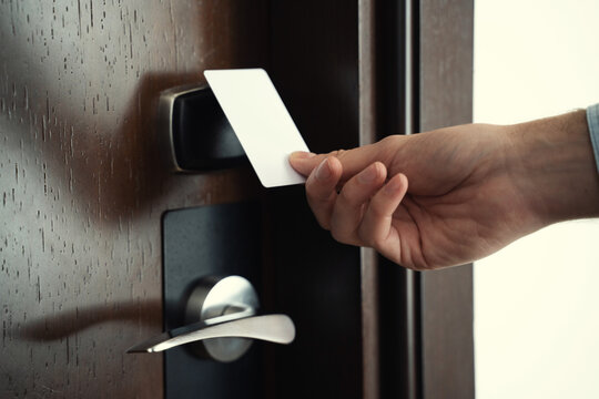 Male Guest Of A Hotel Using Keycard To Get Into His Suite