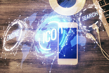 Double exposure of blockchain theme hologram over table with phone. Top view. Crypto technology concept.
