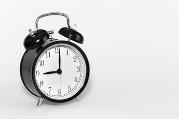 Black clock with white background showing at 9