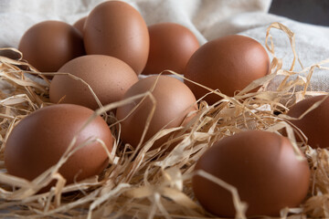 Box of red eggs on a rustic white table. Top view