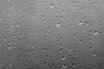 Water drops on glass with vivid medium contrast dark gray color