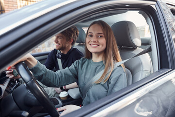 Smiling female driver being pleased with road trip