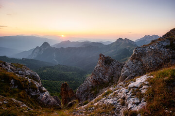 Fototapeta na wymiar Rocky mountain peaks with the sun rising behind