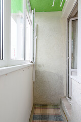 Old balcony in the apartment, glazed with plastic windows