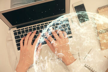 Double exposure of woman hands working on computer and social network theme hologram drawing. Top View. People connection concept.
