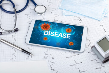 Close-up view of a tablet pc with DISEASE inscription, microbiology concept