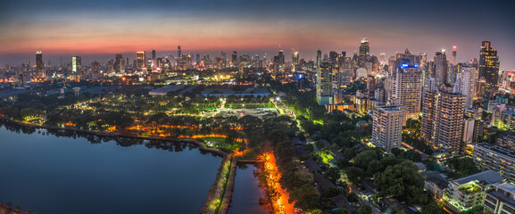 Wide Panoramic View of Bangkok, Thailand. Cityscape with Public Park and Skyscrapers at Twilight.