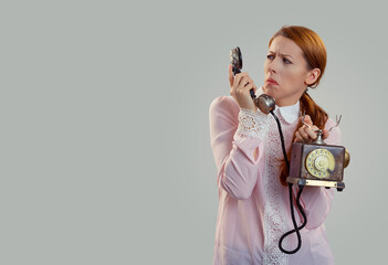 Shocked young woman holding looking at phone
