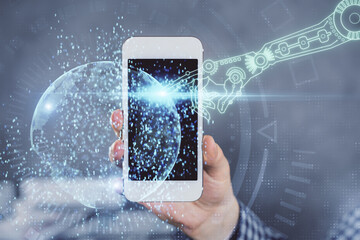 Double exposure of man's hand holding and using a digital device and data theme hologram drawing. Technology concept.