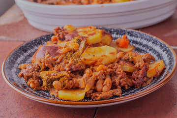 Potato bake with minced pork and beef, on a plate shot close up and from above.