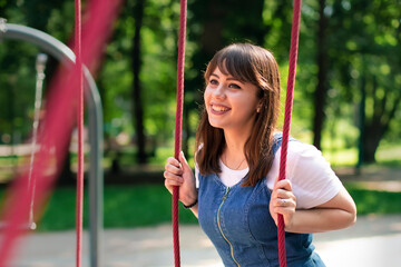 cheerful attractive female portrait white European person adorable smiling face in summer time sunny weather day park area for walking