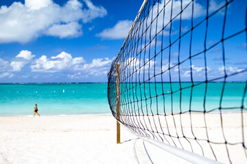 Volleyball net on idyllic white sand beach on tropical