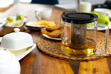Dinner table with glass teapot and cookies