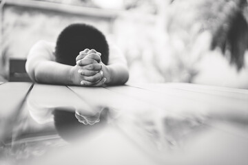 African american boy praying at home.coronavirus Covid-19.Stay at home praying to GOD.Online church...