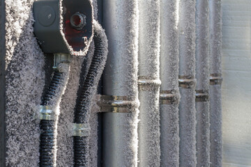The frosted industrial refrigeration compressor pipeline. Frozen ball valve.