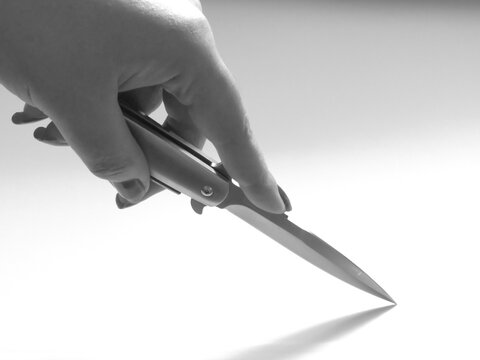 woman's hand and knife switchblade