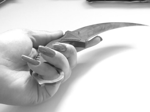 woman's hand and knife switchblade