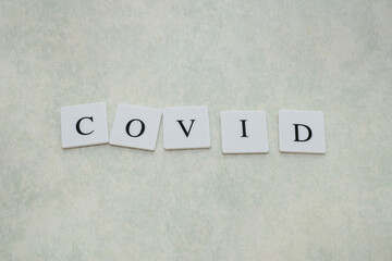 COVID word written on block, concept.
