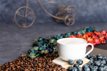 inspirational stones, a cup of morning coffee on a plain background, coffee beans and blueberries