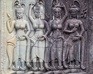 Fototapeta na wymiar Bas-relief of female spirits (apsaras) at Angkor Wat - Siem Reap, Cambodia