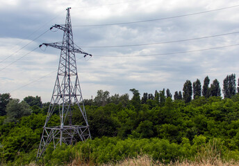Obraz premium High voltage power lines, self-supporting tower with wires, cloudy sky and white clouds