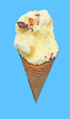 angle view fresh pineapple ice cream cone with couple of bites on blue background