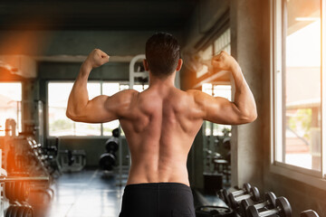 Fototapeta na wymiar athletics strong bodybuilder man posing show his muscle in gym