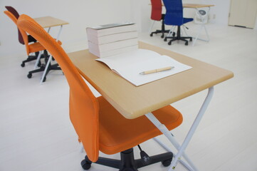 a mechanical pencil, a notebook and a book on the desk