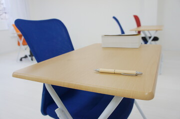 a pen and a book on the desk
