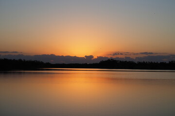 Fototapeta na wymiar Sunrise over tranquil water of Nine Mile Pond in Everglades National Park, Florida on calm clear morning.