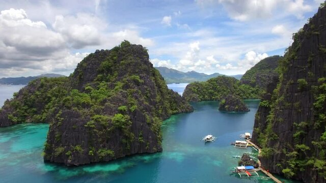 Aerial view of karst scenery and outrigger boats at Kayangan Lake in Coron island, Palawan, Philippines.