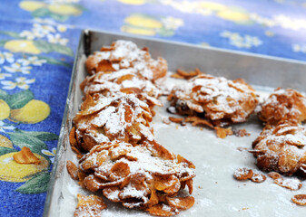 Baking tin with Italian home-made almond cookies on table-cloth