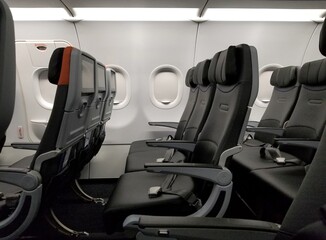The economy passenger seats inside of a plane
