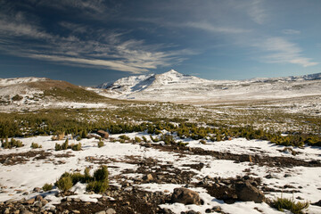 Hiking, The grassland and mountains covered with snow early in the morning in autumn. 
